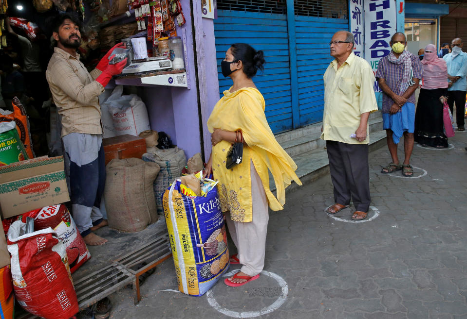 People queue standing in circles drawn to maintain safe distance as they wait to buy grocery items during a 21-day nationwide lockdown to limit the spreading of Coronavirus disease (COVID-19), in Kolkata, India, March 26, 2020. REUTERS/Rupak De Chowdhuri