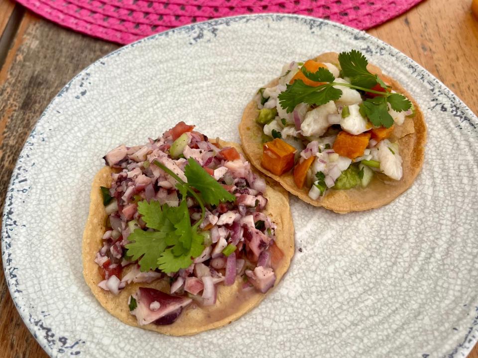 ceviche on a plate next to a sun hat