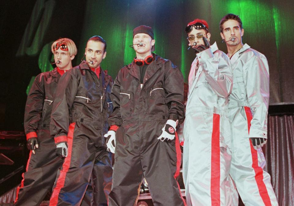 FILE - In this July 8, 1998 file photo, the boy band group the Backstreet Boys, from left, Nick Carter, Howie Dorough, Brian Littrell, A.J. McLean, and Kevin Richardson, perform before a sold out crowd in Charlotte, N.C. The Backstreet Boys were one of the most popular boy bands in the world, selling millions of albums and dominating the music scene in the 90s and 2000s with other groups like *NSYNC. (AP Photo/Rick Havner, file)