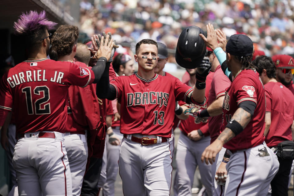 Arizona Diamondbacks' Nick Ahmed is greeted in the dugout after his two-run home run during the second inning of a baseball game against the Detroit Tigers, Saturday, June 10, 2023, in Detroit. (AP Photo/Carlos Osorio)