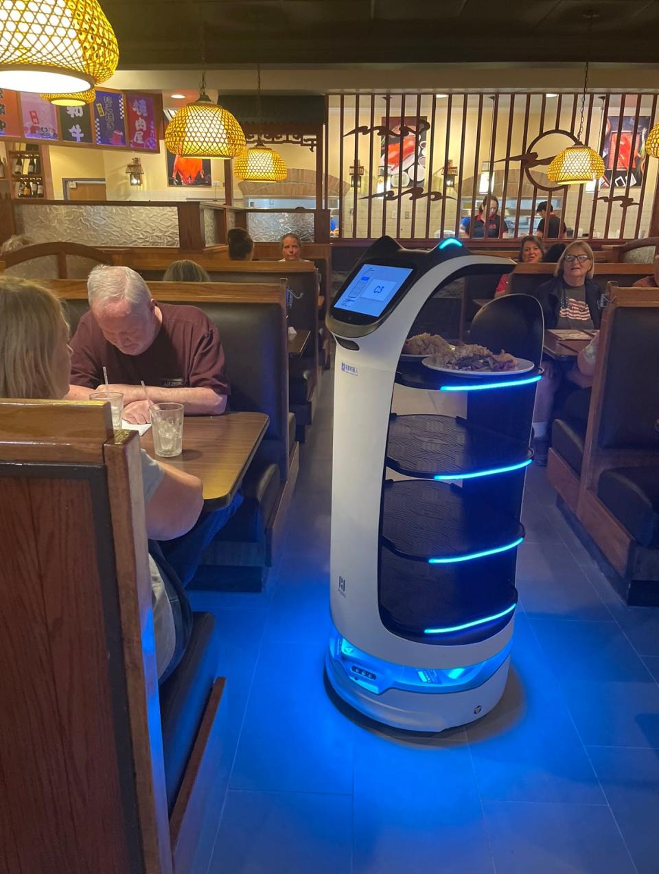 A robot at the new Tian Fu Asian Bistro carries an order from the kitchen to diners Marilyn and Merle Tompkins at Tian Fu Asian Bistro, 7525 E. Washington St., Indianapolis, on June 26, 2023.