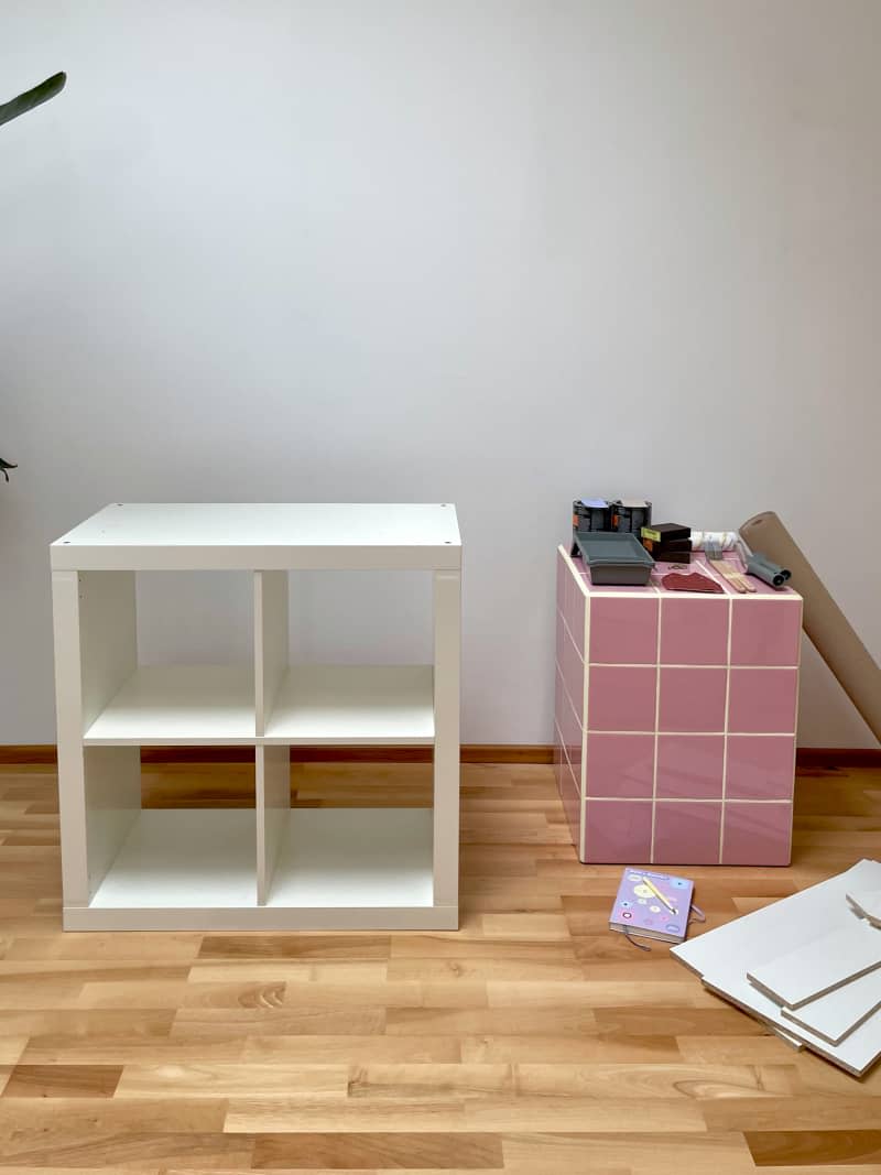 4 cubby white book shelf next to pink tiled cube