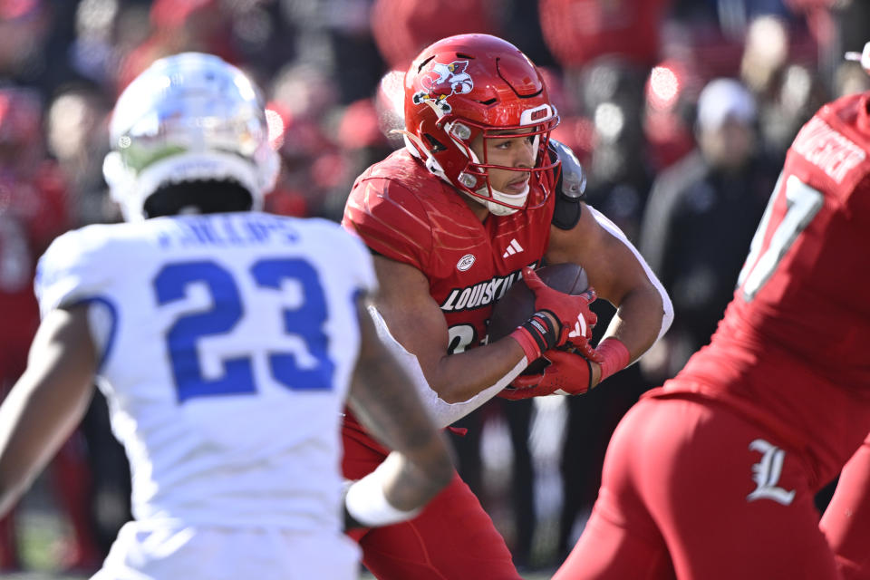 Nov 25, 2023; Louisville, Kentucky, USA; Louisville Cardinals running back Isaac Guerendo (23) runs the ball against the Kentucky Wildcats during the second half at L&N Federal Credit Union Stadium. Kentucky defeated Louisville 38-31. Mandatory Credit: Jamie Rhodes-USA TODAY Sports