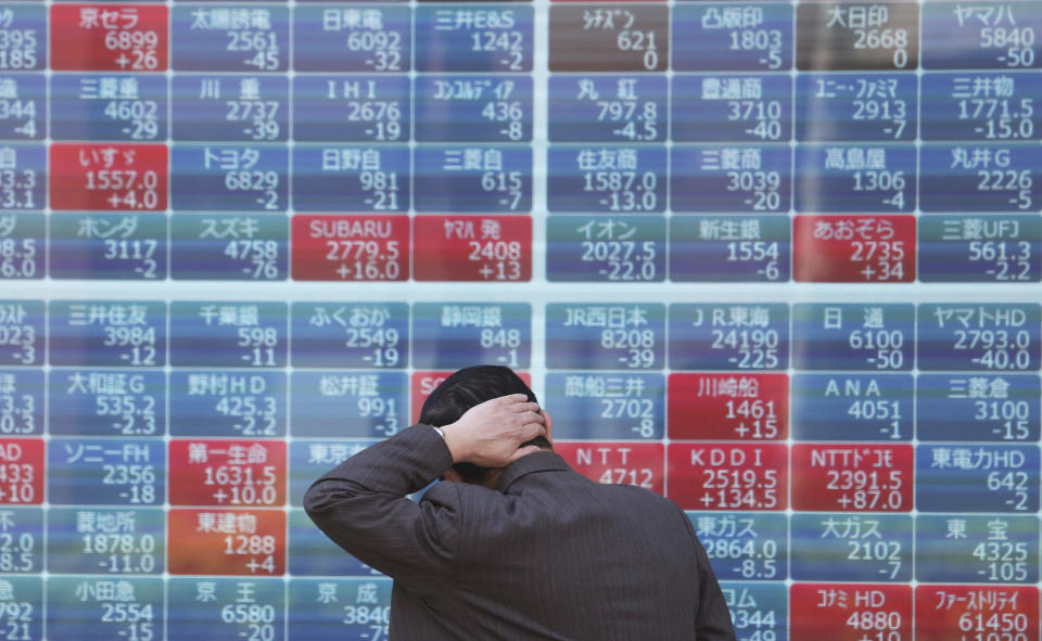 A man looks at an electronic stock board of a securities firm in Tokyo, Tuesday, April 16, 2019. Shares were mixed Tuesday in Asia in mostly narrow trading in the absence of any major market-driving news.(AP Photo/Koji Sasahara)