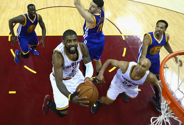 Richard Jefferson watches Kyrie Irving soar high above a flat surface. (Getty Images)