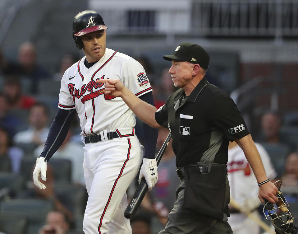 Home plate umpire Lance Barksdale awards Atlanta Braves first baseman Freddie Freeman first base after he was hit by a pitch by Washington Nationals starting pitcher Sean Nolin, who was ejected during the first inning of a baseball game Wednesday, Sept 8, 2021, in Atlanta. (Curtis Compton/Atlanta Journal-Constitution via AP)