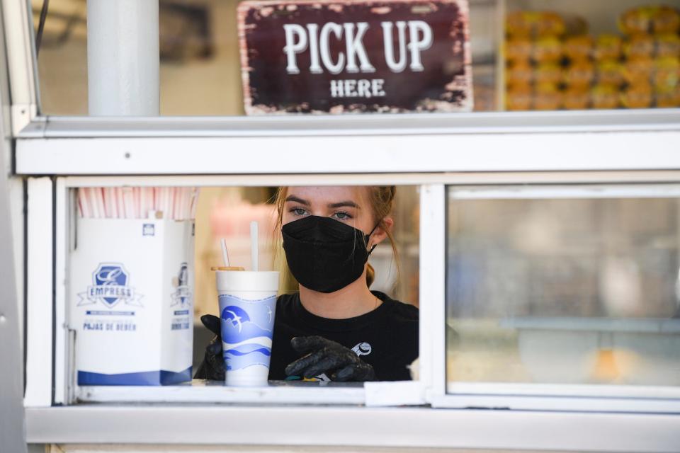 Isabella Gustafson, 14, brings an ice cream treat to the pick up window during the opening day of the season at Snookies Malt Shop Saturday, March 26, 2022, in Beaverdale. 