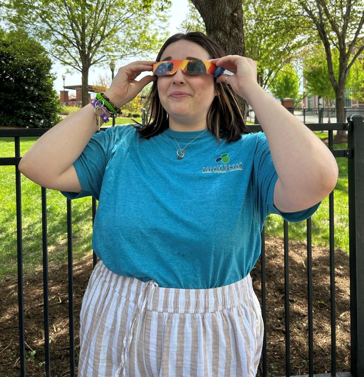 Mae Webster demonstrating the eclipse glasses