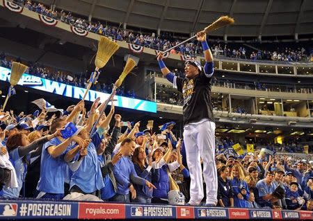 Oct 5, 2014; Kansas City, MO, USA; Kansas City Royals catcher Salvador Perez (13) celebrates with fans after defeating the Los Angeles Angels in game three of the 2014 ALDS baseball playoff game at Kauffman Stadium. The Royals won 8-4 advancing to the ALCS against the Baltimore Orioles. Mandatory Credit: Peter G. Aiken-USA TODAY Sports