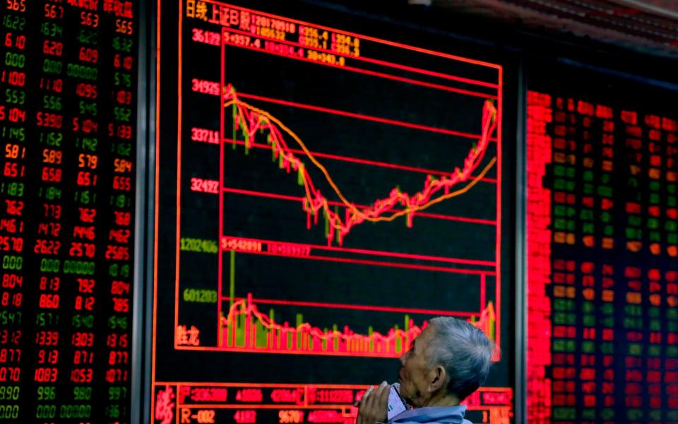 Stocks in Shanghai and Hong Kong have been hit by trade war worries - AP