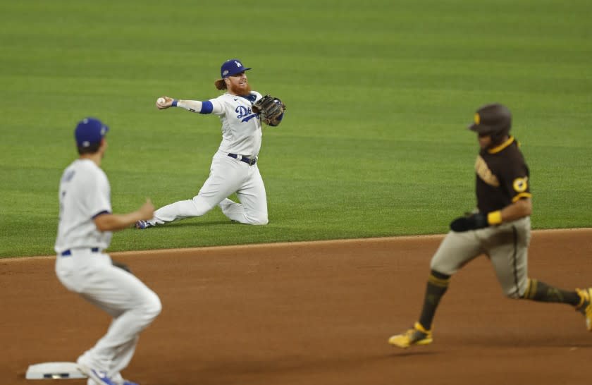 Justin Turner of the Los Angeles Dodgers fields a hit by Jake