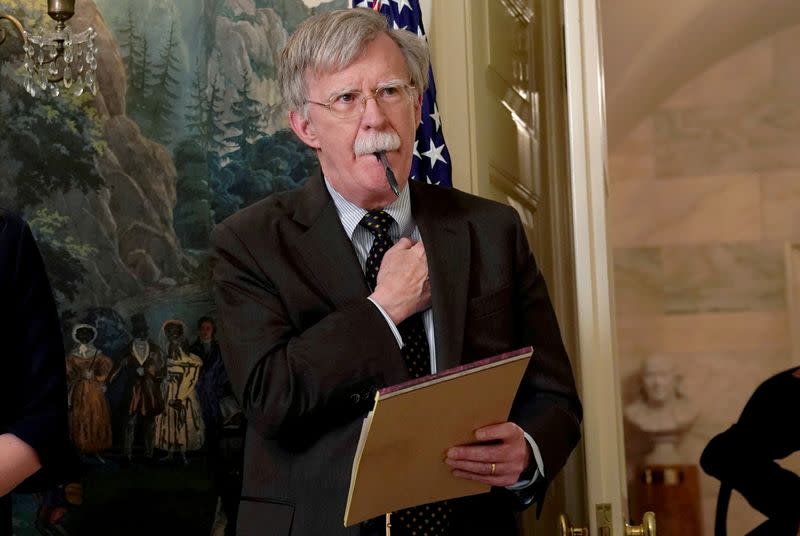 FILE PHOTO: Former U.S. National Security Adviser John Bolton listens to President Donald Trump make a statement about Syria