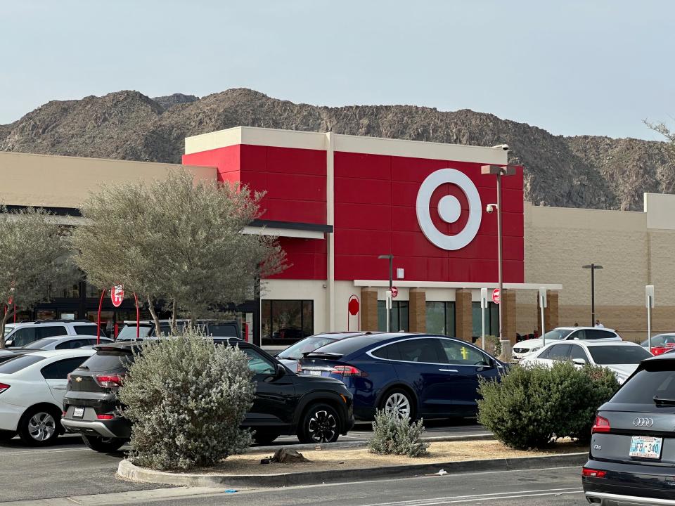 The exterior of a Target store next to a mountain.