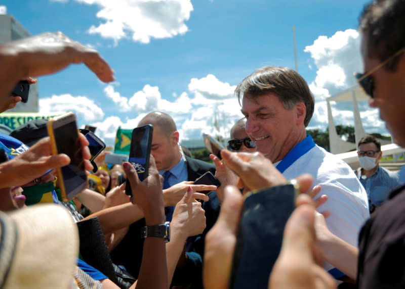 FILE PHOTO: Brazil's President Bolsonaro meets supporters during a protest against Brazil's Congress and Brazilian Supreme Court, in front of the Planalto Palace in Brasilia