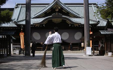 A shrine attendant cleans at the Yasukuni Shrine before its Annual Spring Festival in Tokyo April 22, 2014. REUTERS/Yuya Shino