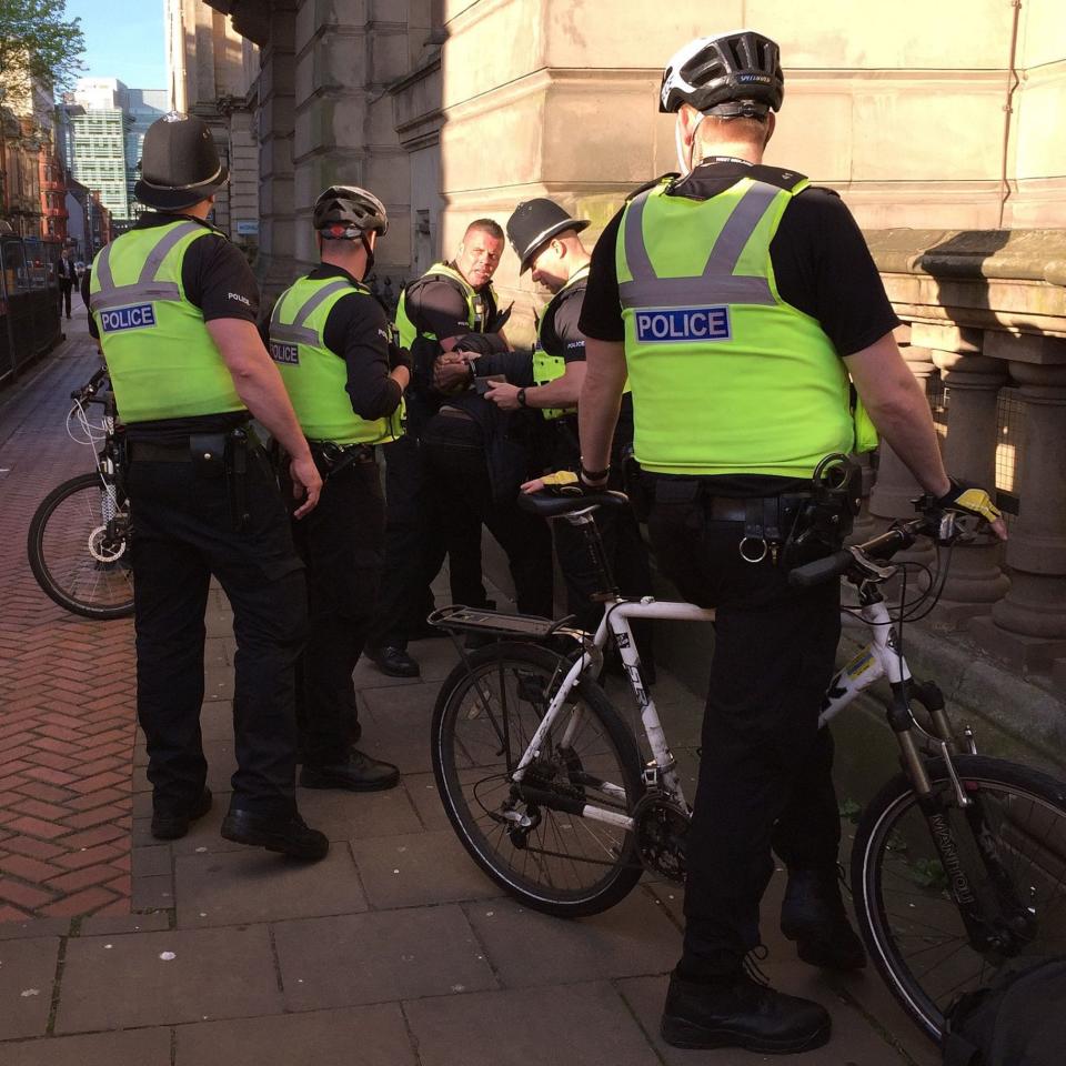 A man is detained near to a candle-lit vigil being held in Birmingham - Credit: Richard Vernalls/PA Wire