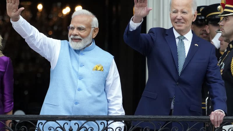 India’s Prime Minister Narendra Modi and President Joe Biden wave from the Blue Room Balcony during an Arrival Ceremony on the South Lawn of the White House, Thursday, June 22, 2023, in Washington.