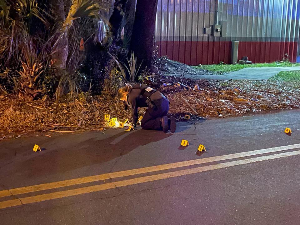 An Ocala Police Department evidence technician takes pictures at a crime scene late Thursday night