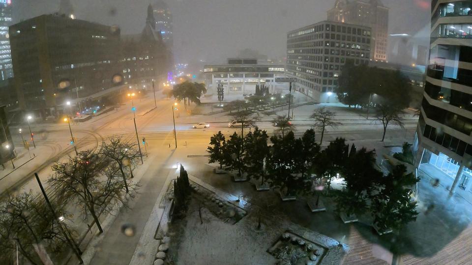 Snow accumulates on the street on North Broadway and Kilbourn as the first snow falls in Milwaukee on Tuesday, Oct. 31, 2023.