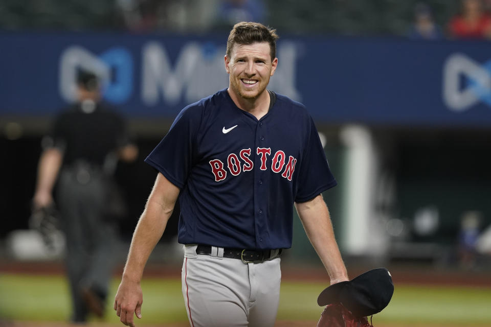 Boston Red Sox starting pitcher Nick Pivetta smiles as he walks to the dugout after the final out of the sixth inning of the team's baseball game against the Texas Rangers in Arlington, Texas, Friday, May 13, 2022. The Red Sox won 7-1. (AP Photo/LM Otero)