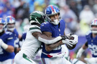 New York Giants tight end Darren Waller (12) runs the ball against New York Jets cornerback Sauce Gardner (1) during the first half of an NFL football game, Sunday, Oct. 29, 2023, in East Rutherford, N.J. (AP Photo/Frank Franklin II)