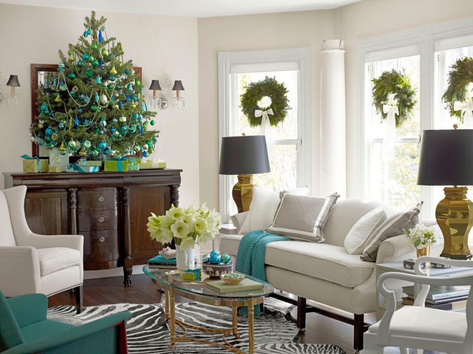 <p>For the living room's tree, the homeowners of this home limited themselves to basic glass ornaments in a handful of shades: blue, green, and gold. The presents beneath it benefit from a similar restraint.</p><p><a class="link " href="https://www.amazon.com/Emopeak-24Pcs-Christmas-Balls-Ornaments/dp/B07X1Z4CZX/ref=sr_1_6?dchild=1&keywords=green+ornaments&qid=1603207934&s=home-garden&sr=1-6&tag=syn-yahoo-20&ascsubtag=%5Bartid%7C10050.g.1251%5Bsrc%7Cyahoo-us" rel="nofollow noopener" target="_blank" data-ylk="slk:SHOP ORNAMENTS;elm:context_link;itc:0;sec:content-canvas">SHOP ORNAMENTS</a></p>