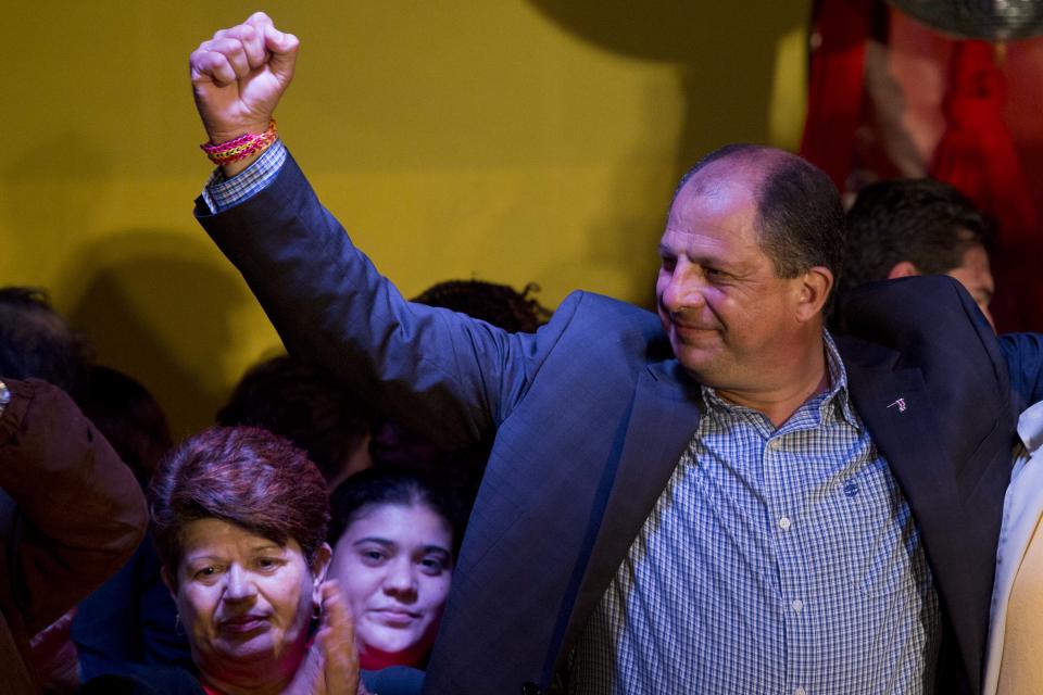 Luis Guillermo Solis, presidential candidate of the Citizen Action Party, celebrates with his supporters in San Jose, Costa Rica, Sunday, Feb. 2, 2014. According to preliminary results by election officials, Solis and National Liberation Party candidate Johnny Araya will have a runoff for the presidency April 6. (AP Photo/Moises Castillo)