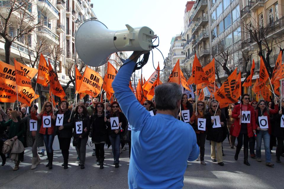 Protesters shout anti-austerity slogans whilst holding letters reading "Beware of suspension" referring to civil servants, during a rally in the northern Greek port city of Thessaloniki, Wednesday, March 12, 2014. A 24-hour strike by civil servants disrupted public services in Greece Wednesday as the country’s government struggled to hammer out a deal on further austerity measures with international creditors. Thousands of protesters attended rallies in Athens and other Greek cities, while civil servants have penciled in another 48-hour strike on March 19-20. (AP Photo/Nikolas Giakoumidis)