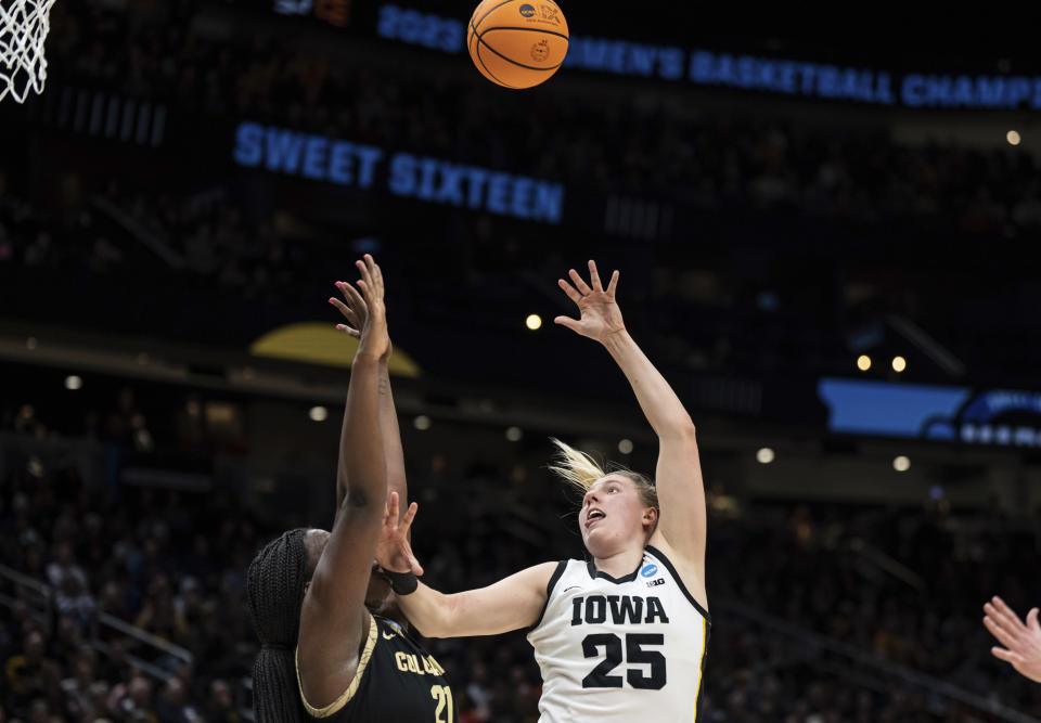 Iowa forward Monika Czinano, right, shoots over Colorado center Aaronette Vonleh during the second half of a Sweet 16 college basketball game in the women's NCAA tournament Friday, March 24, 2023, in Seattle. Iowa won 87-77. (AP Photo/Stephen Brashear)