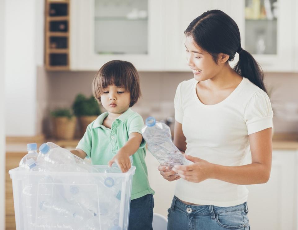 Asian Mother Teaching Son to Recycle