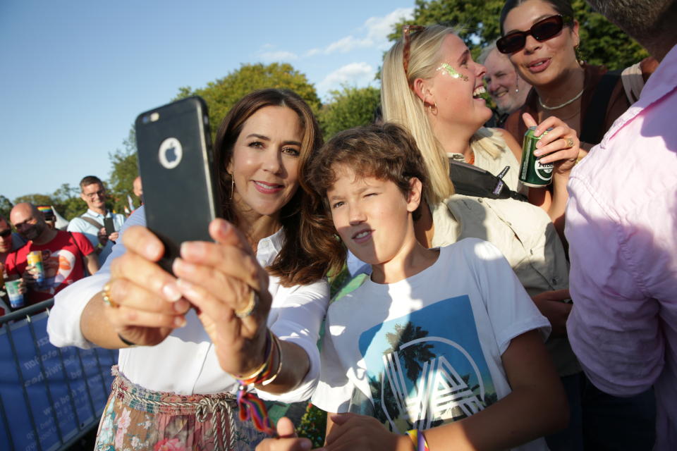 Danish Crown Princess Mary takes selfies with the crowd during the WorldPride in Copenhagen, Denmark August 21, 2021. Olafur Steinar Gestsson/Ritzau Scanpix/via REUTERS    ATTENTION EDITORS - THIS IMAGE WAS PROVIDED BY A THIRD PARTY. DENMARK OUT.