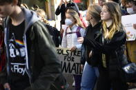 Greta Thunberg, in white jacket at left, takes part in "global climate strike" demonstration, organized by Fridays For Future in central Stockholm, Friday, Oct. 22, 2021. (Erik Simander/TT via AP)