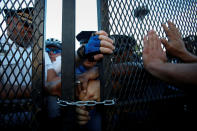 <p>Police attempt to lock a gate as supporters of Senator Bernie Sanders attempt to break past the perimeter walls at the 2016 Democratic National Convention in Philadelphia, Pennsylvania, July 26, 2016. (Photo: Adrees Latif/Reuters)</p>