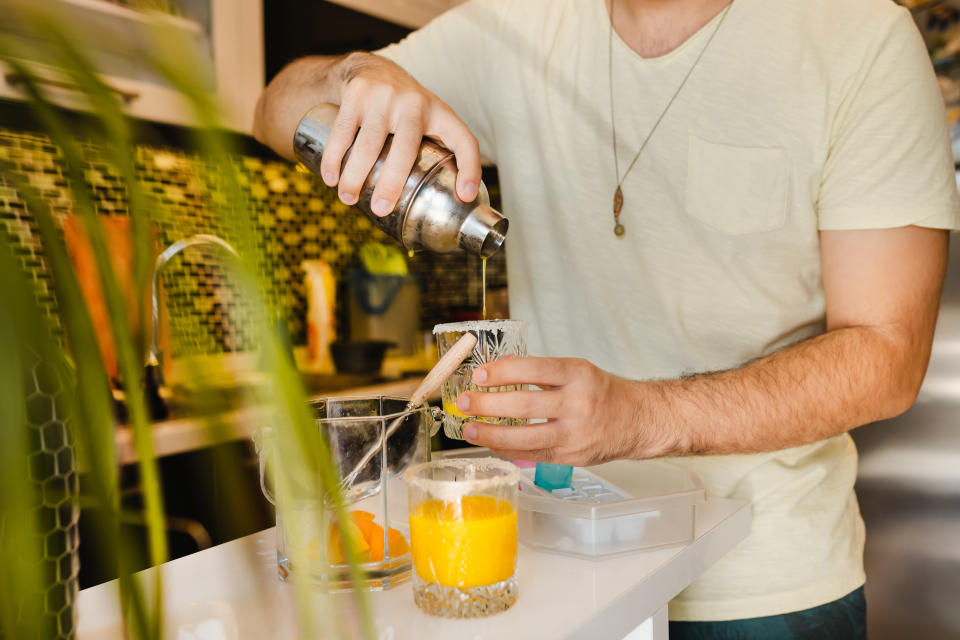 A man pouring a drink into a glass