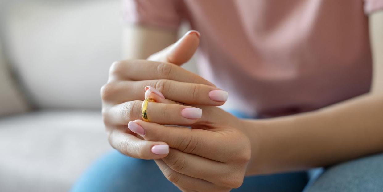 woman taking off wedding ring