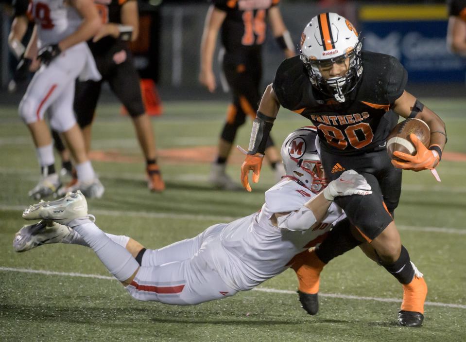 Morton's Carl Whitaker (2) puts a diving tackle on Washington's Adrian Jones in the second half Friday, Oct. 21, 2022 in Washington. The Panthers defeated the Potters 7-0.