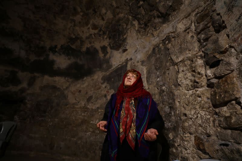 A worshipper prays inside the Syrian Orthodox section of the Church of the Holy Sepulchre, revered as the site of Jesus's crucifixion and burial, in Jerusalem's Old City