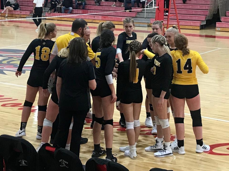 Northmor's volleyball team meets during a timeout at the Division IV district semifinal match at Worthington Christian last season.