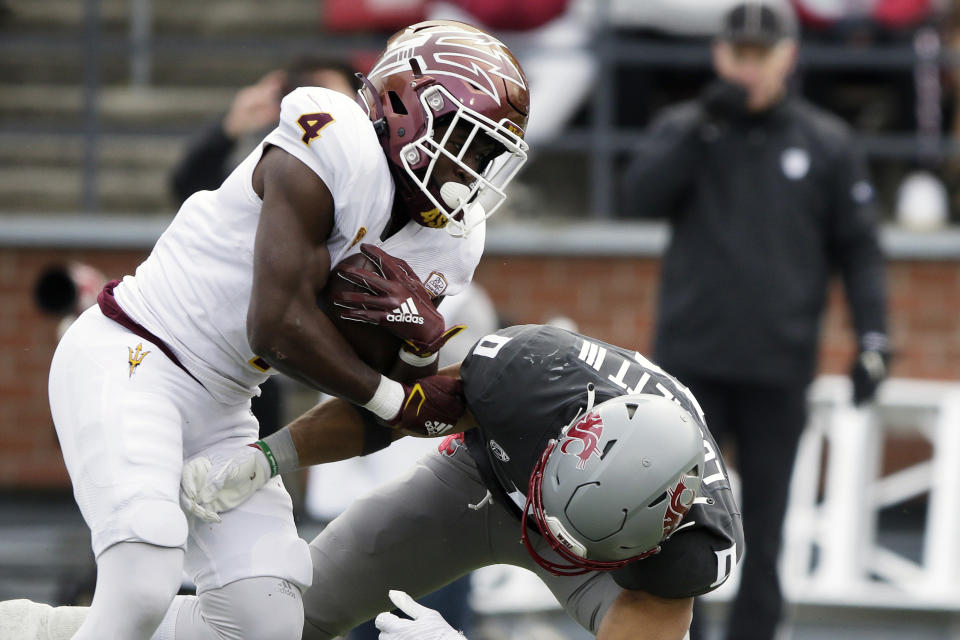 Arizona State running back Daniyel Ngata (4) tries to get past Washington State defensive back Sam Lockett III (0) during the first half of an NCAA college football game, Saturday, Nov. 12, 2022, in Pullman, Wash. (AP Photo/Young Kwak)