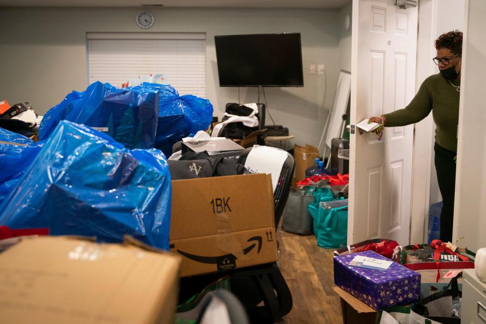 Olethia Craighead, 46, closes the door to a room filled with Christmas gifts for boys at Christ Child House in Detroit on Dec. 12, 2022.