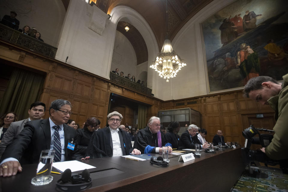 Myanmar's agent, Union Minister Kyaw Tint Swe, left, and members of the delegation take their seats at the International Court in The Hague, Netherlands, Thursday, Jan. 23, 2020. The United Nations' top court is scheduled to issue a decision on a request by Gambia to order Myanmar to halt what has been cast as a genocidal campaign against the southeast Asian country's Rohingya Muslim minority. (AP Photo/Peter Dejong)