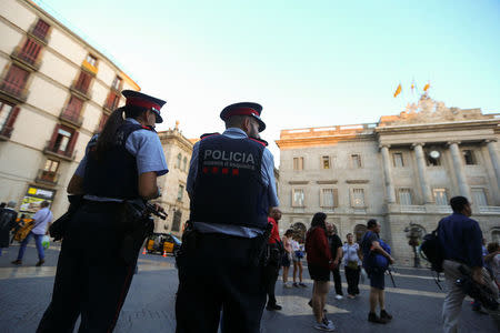 Mossos d'Esquadra officers, Catalan regional force, stand guard at Sant Jaume square in Barcelona, Spain, October 16, 2017. REUTERS/Ivan Alvarado