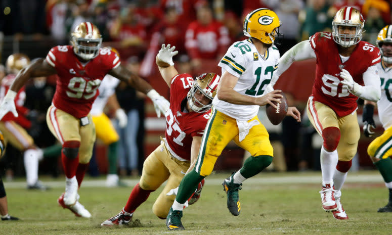 Aaron Rodgers rolls out for a pass against the 49ers.