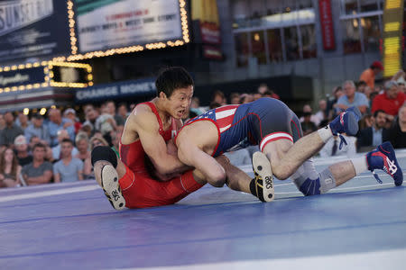 Japanese wrestler Daichi Takatani (L) spars with U.S. wrestler Zain Retherford at the "Beat The Streets" wrestling event in Times Square, New York City, U.S., May 17, 2017. REUTERS/Joe Penney