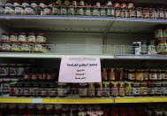 A notice calling for a boycott French products is displayed at a supermarket in Sanaa, Yemen, Monday, Oct. 26, 2020. Muslims in the Middle East and beyond on Monday called for boycotts of French products and for protests over caricatures of the Prophet Muhammad they deem insulting and blasphemous, but France's president has vowed his country will not back down from its secular ideals and defense of free speech. (AP Photo/Hani Mohammed)