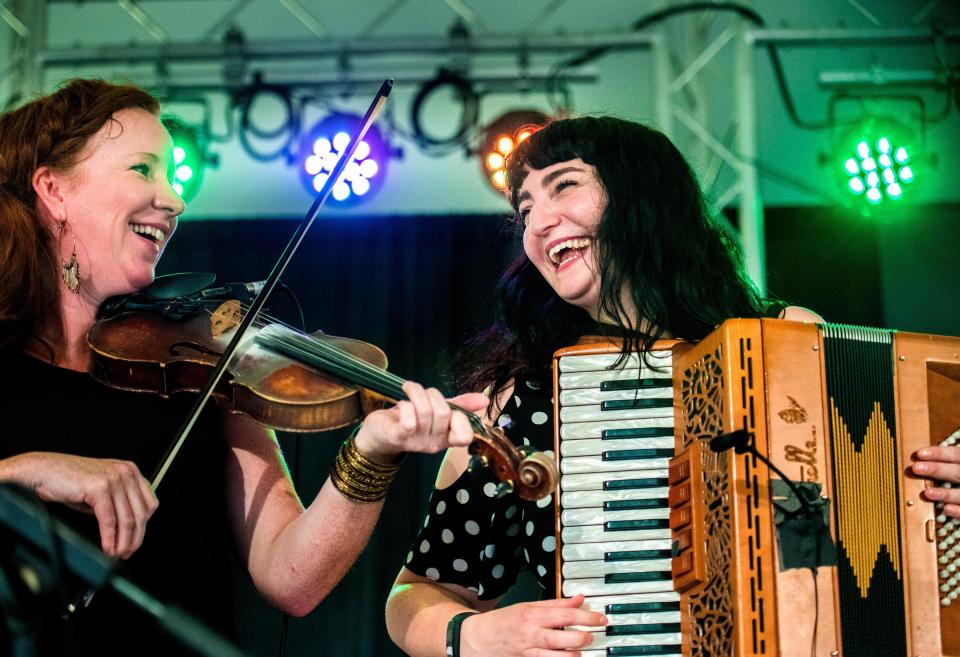 Mairi Rankin and Fiona Black laugh as the Celtic band Outside Track plays during Peoria Irish Fest on the Peoria Riverfront.