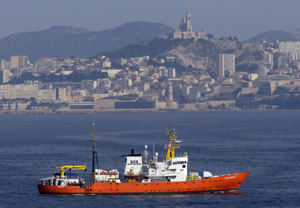 FILE - In this Aug.1, 2018 file photo, the French NGO "SOS Mediterranee" Aquarius ship leaves the Marseille harbor, southern France. he European Commission said Monday Aug.13, 2018 that it is in contact with a number of member states to identify a country willing to take 141 migrants picked up by a rescue ship, after the French aid groups operating the ship appealed for a safe port and Italy said Britain should take responsibility. (AP Photo/Claude Paris, File)