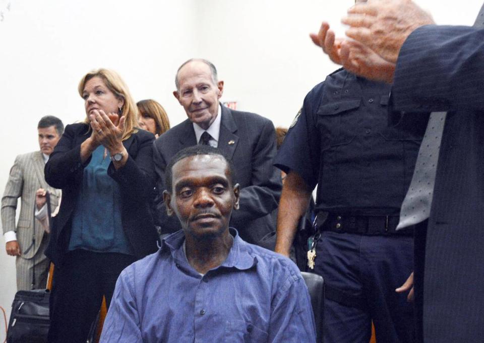 Henry McCollum sits stunned as applause rings out in a Robeson County courtroom in 2014 after a judge declared McCollum and his brother Leon Brown innocent of a brutal rape murder for which they spent 30 years in prison.