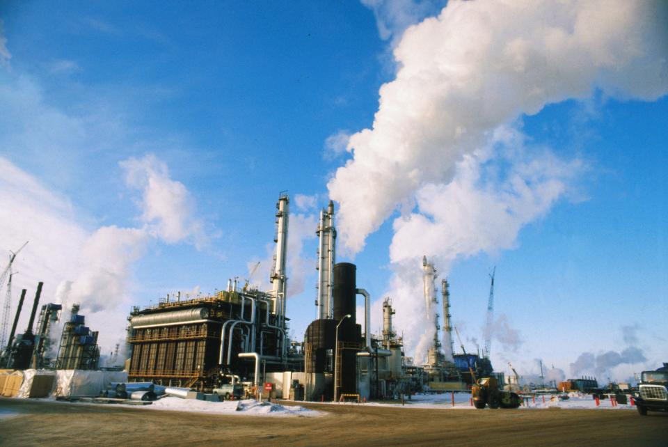 hydrogen power plant with tall stacks emitting steam clouds into a blue sky