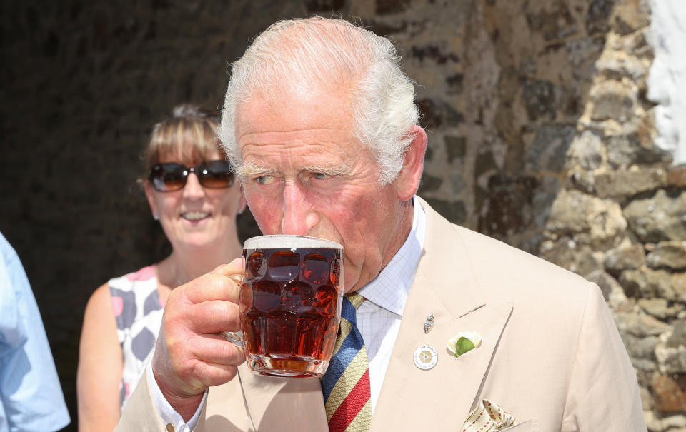 IDDESLEIGH, ENGLAND - JULY 21: Prince Charles, Prince of Wales drinks a pint of ale as he visits the Duke of York Inn to join author Sir Michael Morpurgo at a lunch club for local residents, with Camilla, Duchess of Cornwall during Day 3 of their visit to Devon and Cornwall on July 21, 2021 in Iddesleigh, England.  (Photo by Chris Jackson/Getty Images)